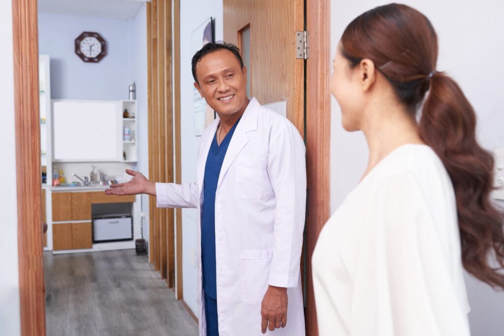 Doctor welcoming a patient into the office